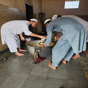 Serving Biryani in madarsa by Maulana